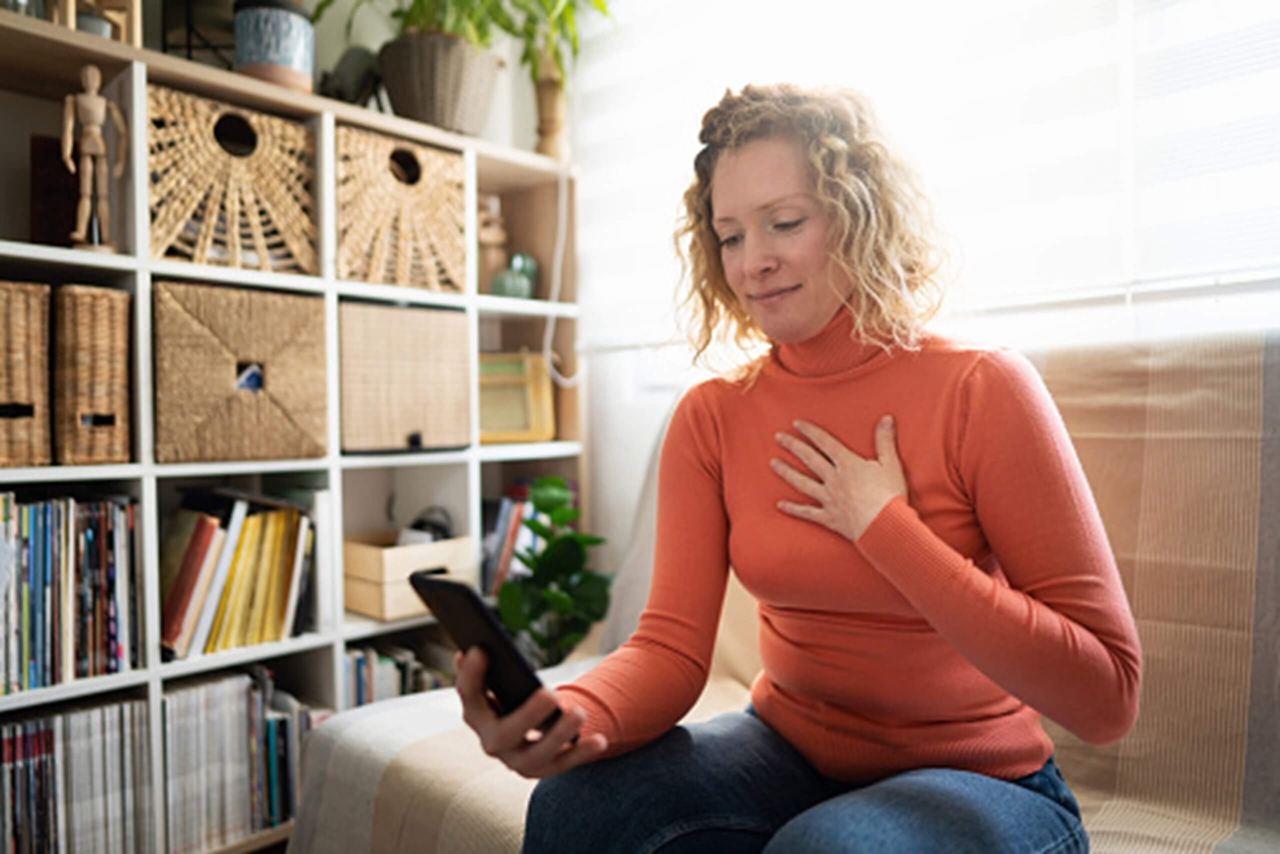 A woman holding her chest, reflecting the impact of obsessive-compulsive disorder in Dallas, TX