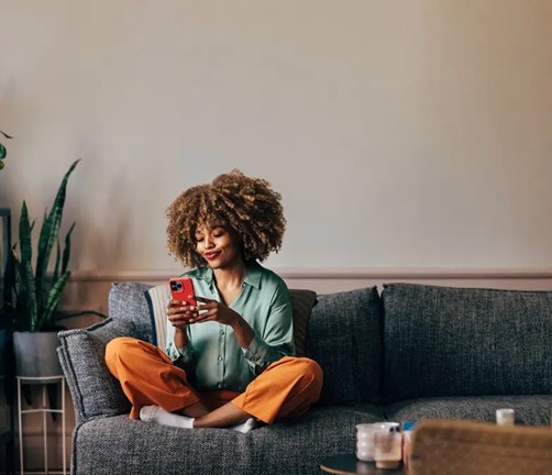An excited young woman shopping on her cellphone