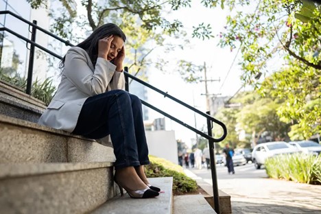 Businesswoman relieving stress outside in public